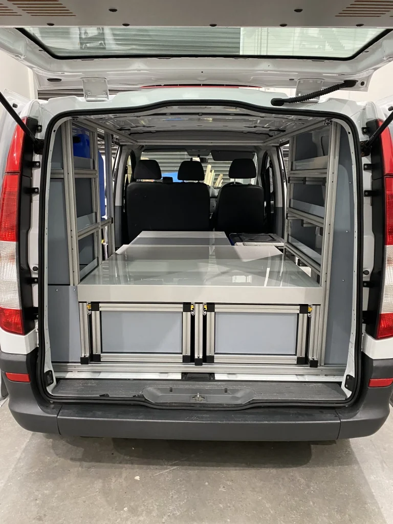 Van interior with custom shelving and drawers. Engineered Solutions for vehicle storage.