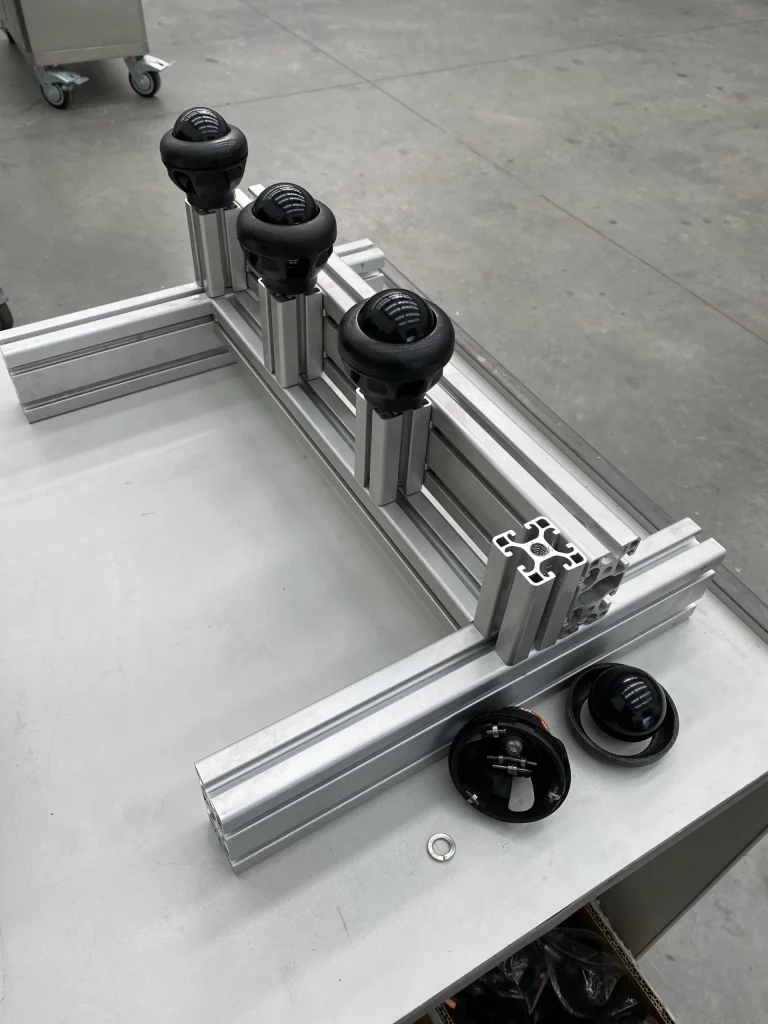 Industrial ball transfer units mounted on aluminum extrusion framing, showcasing custom engineering solutions.